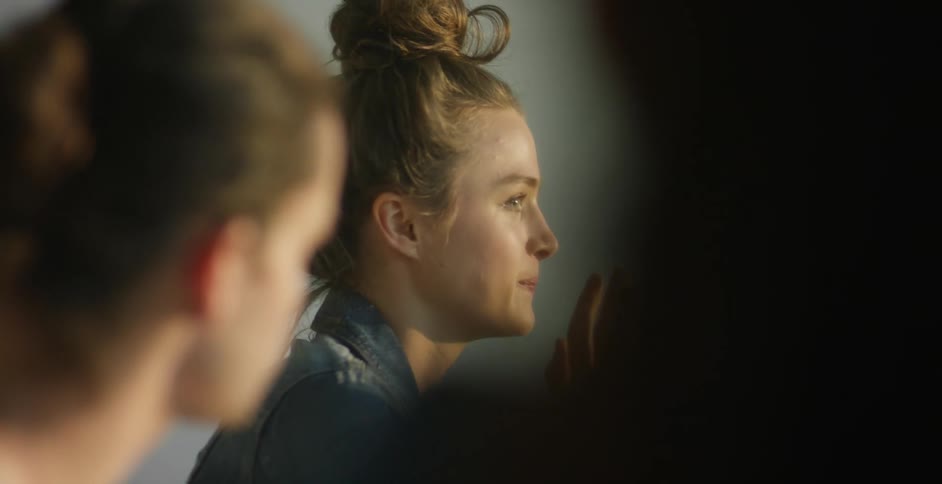 A person with their hair in a bun