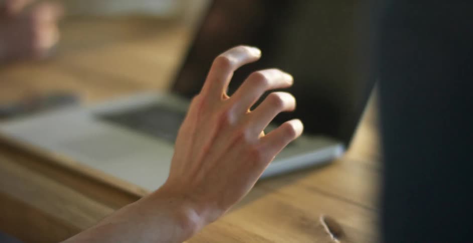 A person stretches and drums their fingers