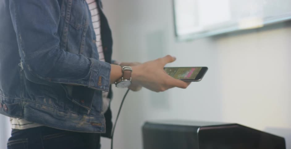A smartphone is plugged in to charge