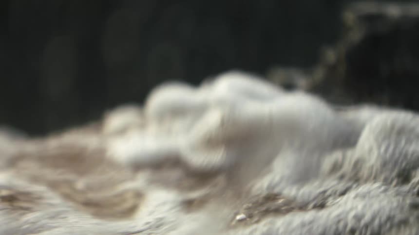 Flowing bubbling water in nature