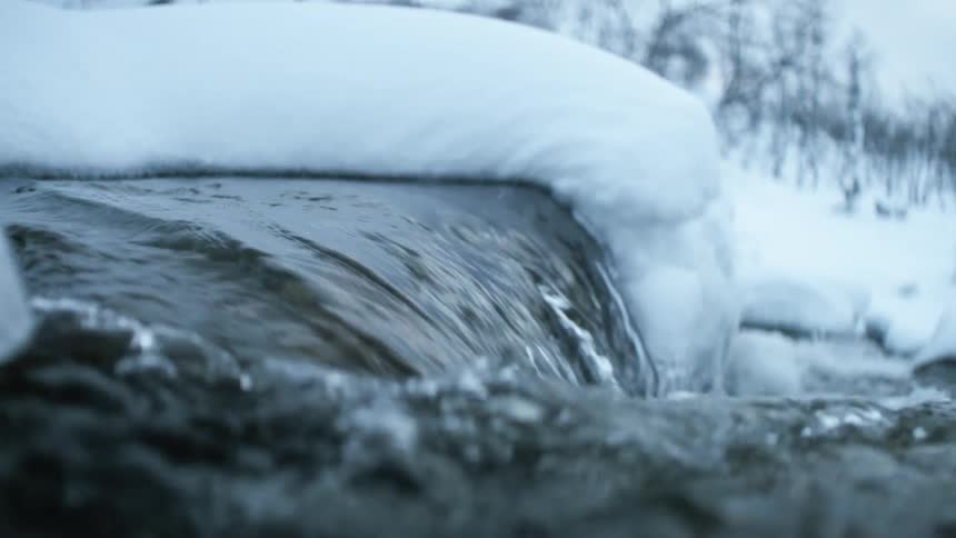 A view of water flowing in a river during winter