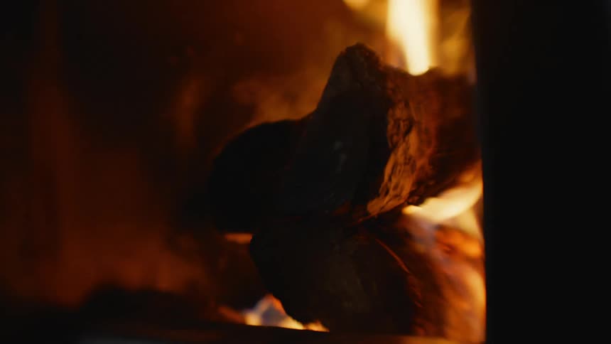 Fire and flames on the logs in a campfire at night