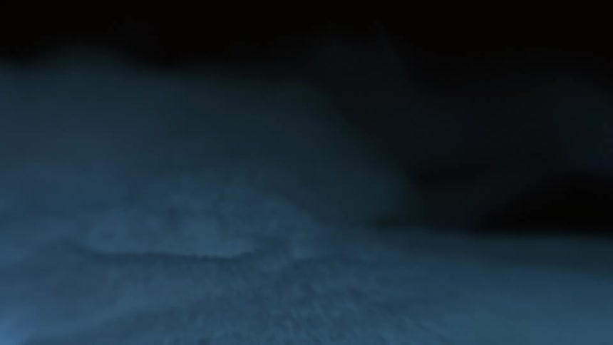 Ground covered in snow with a storm with flashing thunder at night