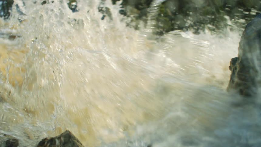 The water is crashing against the rocks