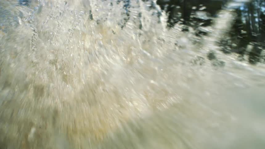 Splashing water coming down a waterfall in the forest