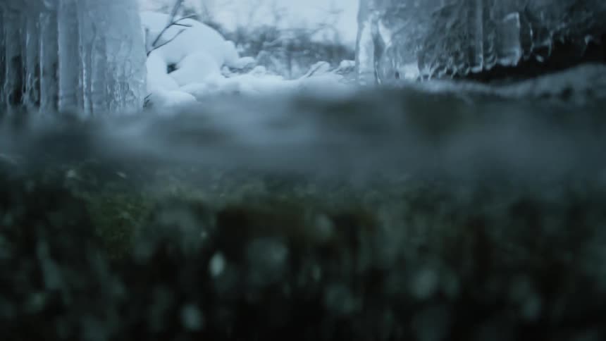 River water flowing through a snowy landscape in winter