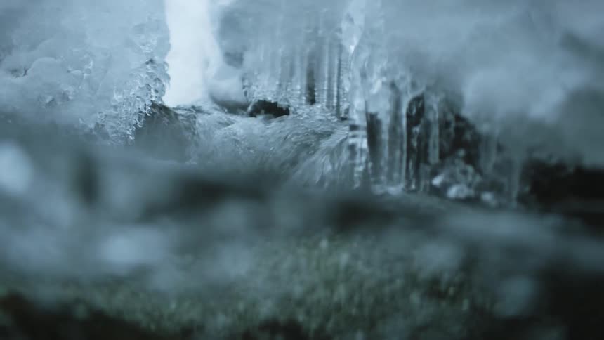 A stream of water with bubbles rock and ice