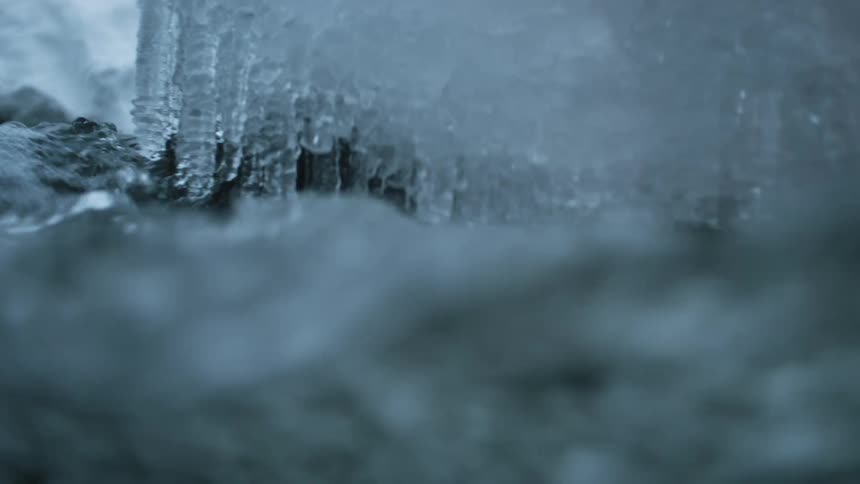 The water flows past the melting ice