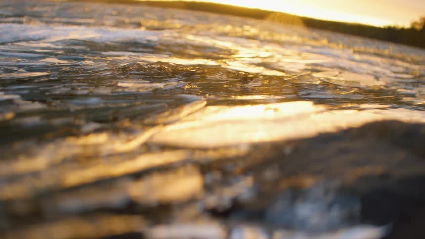 Close up of ice on a lake at sunset
