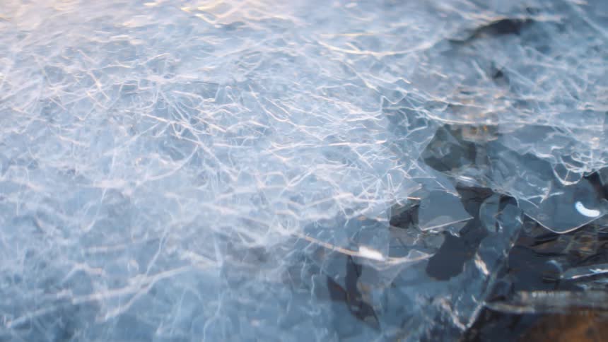 Thin sheets of ice stacked on top of each other melting