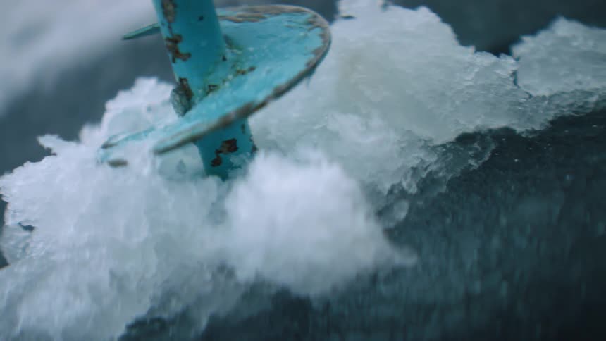 Drill drilling into ice