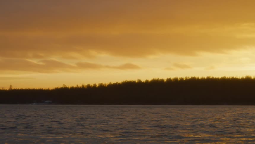 The yellow sky above a lake at sunset