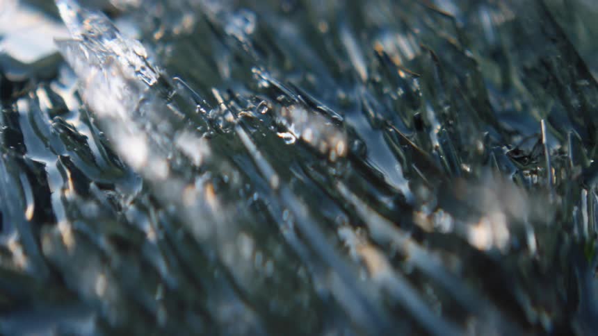 Water slowly flowing over an ice sheet outdoors