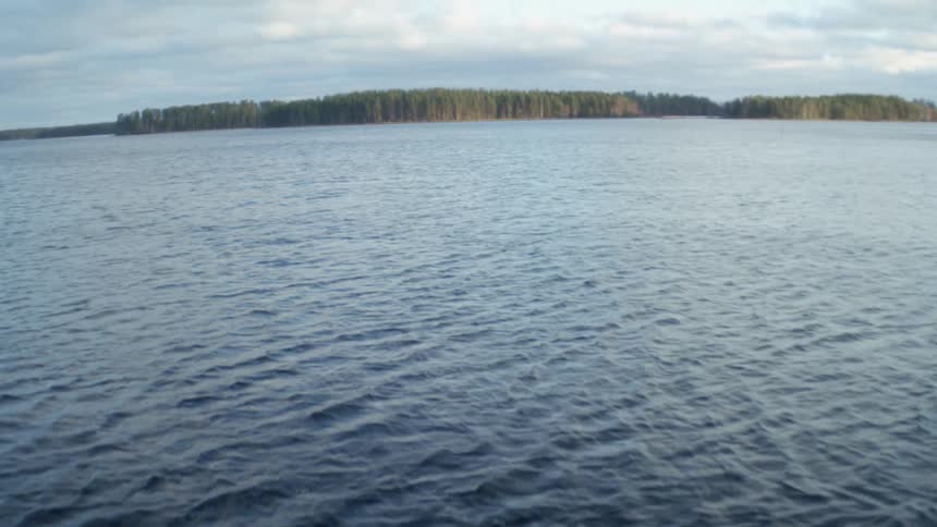 Lake water rippling with land in the distance