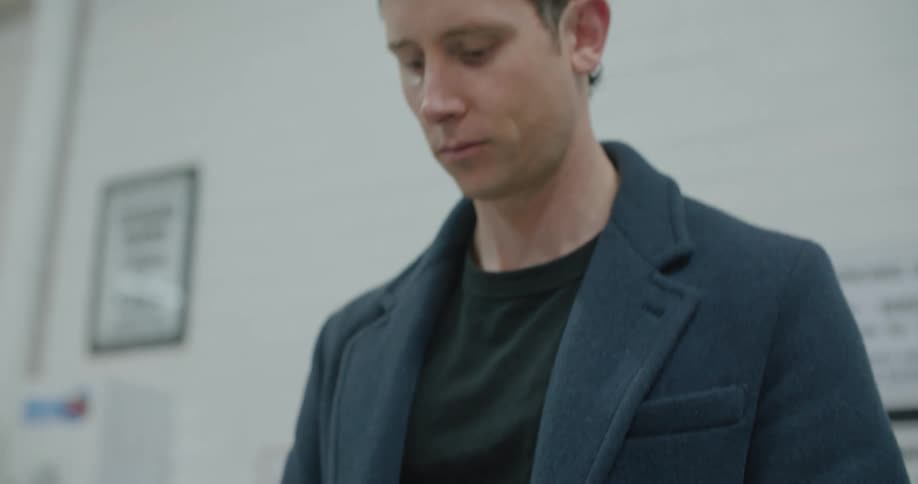 Young man folding a pair of socks to pack them in luggage