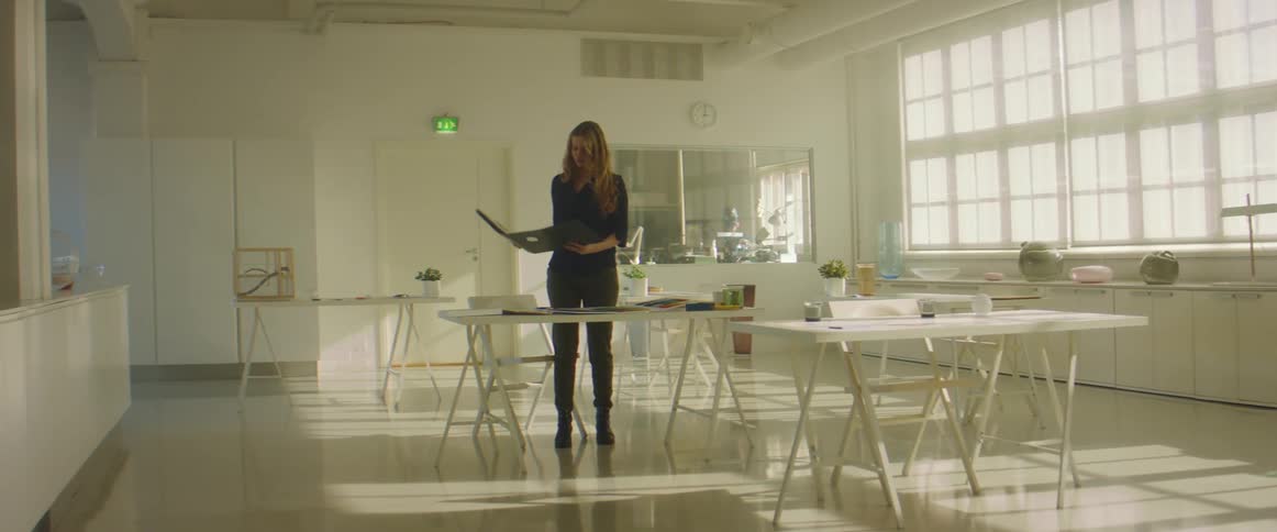 Woman checking samples and brochures over a desk in an office