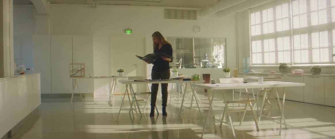 Woman checking samples and brochures over a desk in an office