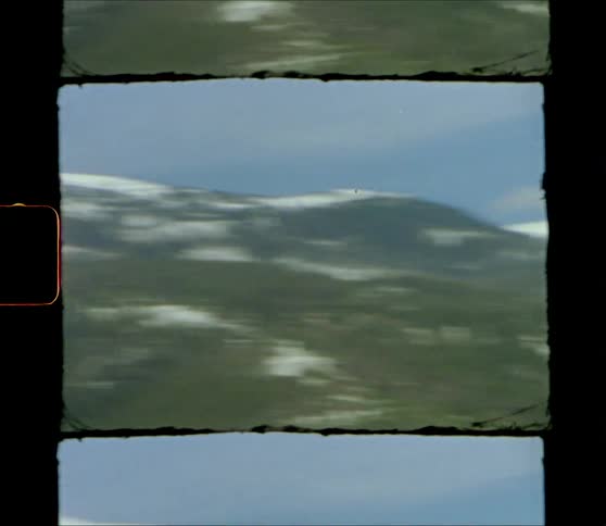 A snow covered mountain range with the sky and clouds in the background