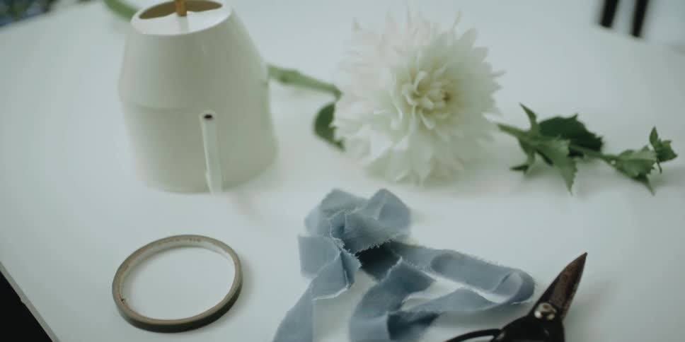 Floristry equipment laying over a white table