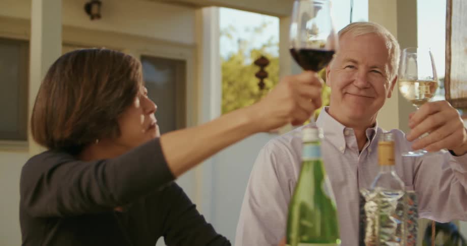 Friends are drinking wine and sitting at a table together