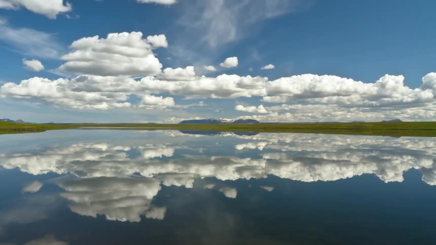 Cloud filled sky reflecting on the water