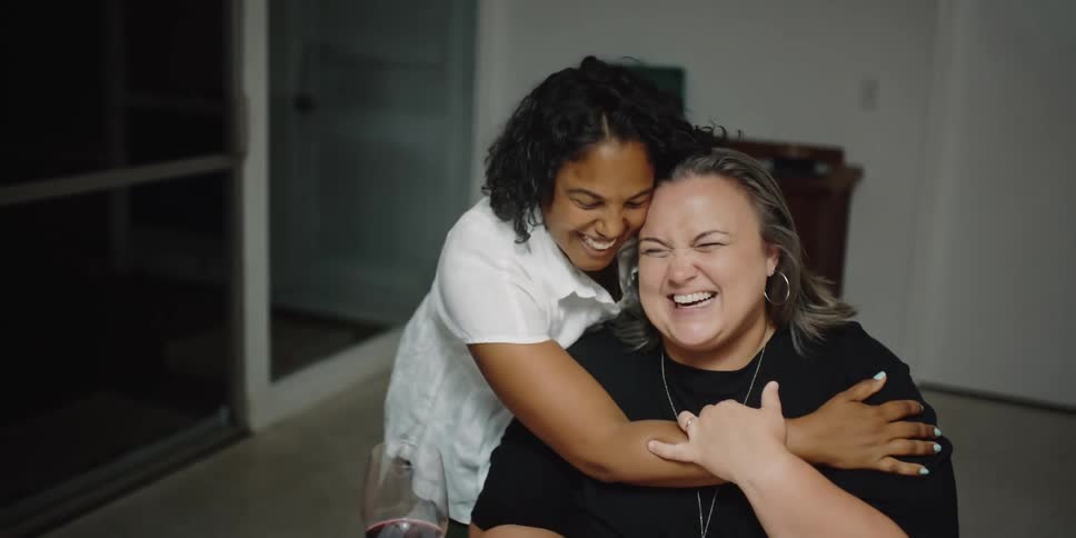Two women hugging and smiling