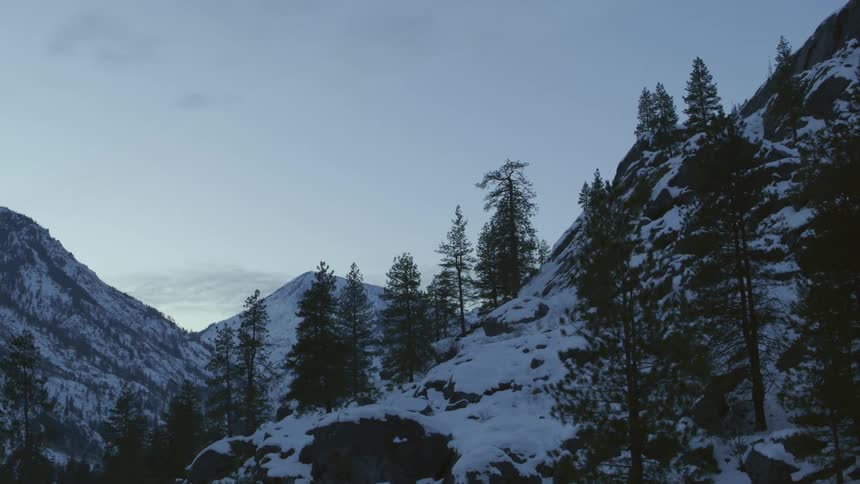 Revealing a snow dusted mountain valley at dusk