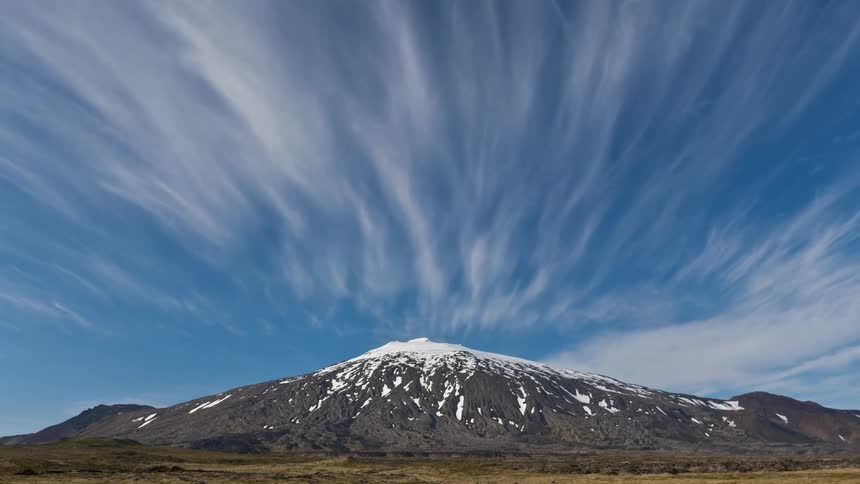 Time lapse of clouds moving over a mountain top