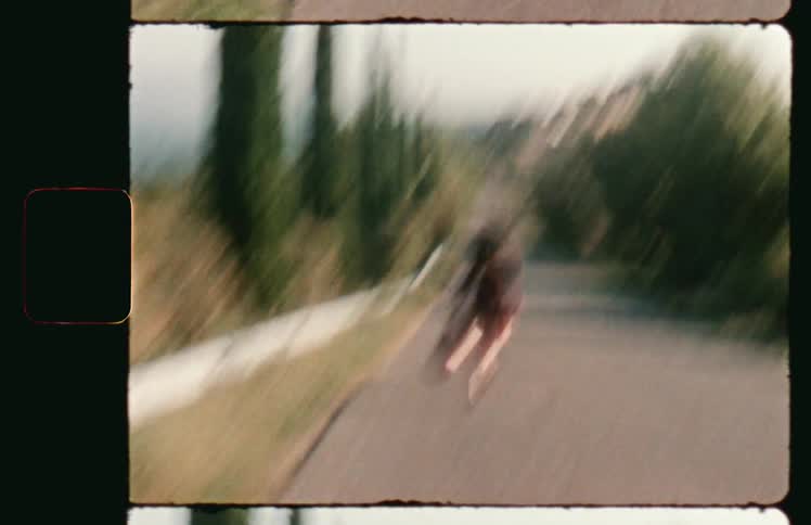 A woman excitedly runs down an asphalt road in the countryside during the day