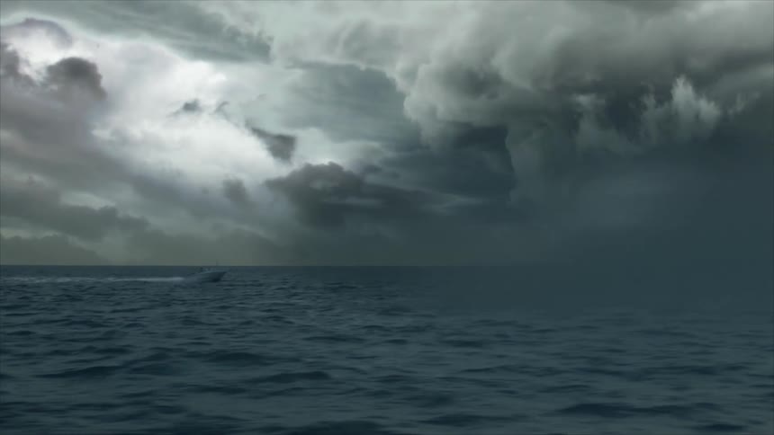 A motor boat drives into a violent hurricane