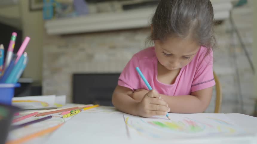 A child coloring on a piece of paper