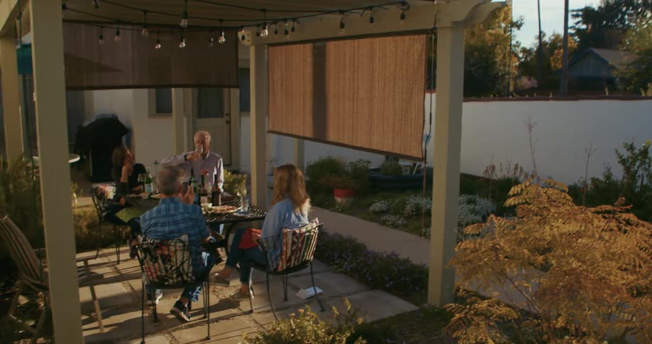 A group of people that are sitting on a back patio
