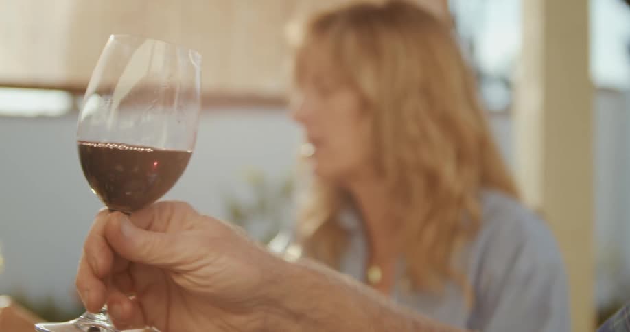 A man and woman are drinking wine together