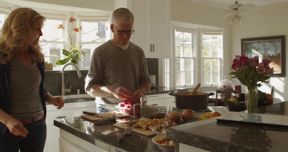 Husband and wife are cooking in their kitchen