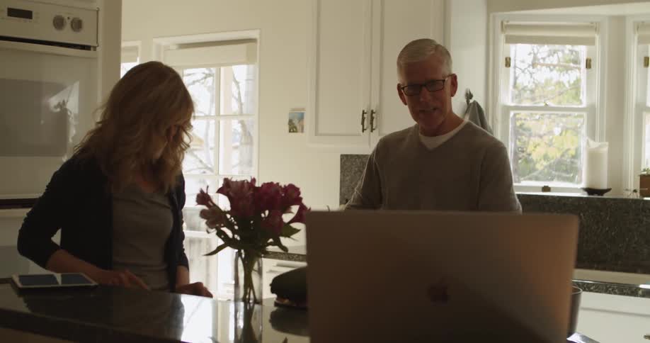 A man and woman in a kitchen together