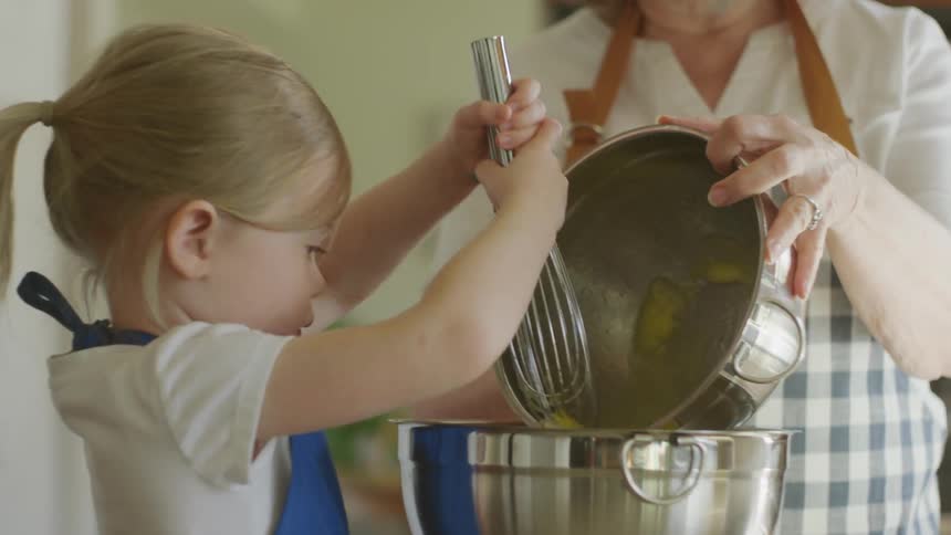 Child baking with family member