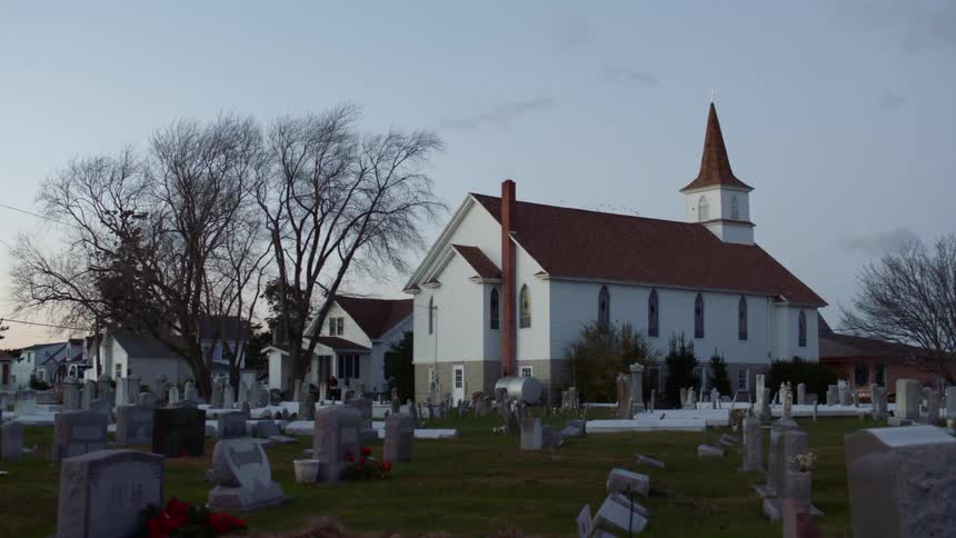 Gravestones in a cemetery outside a church