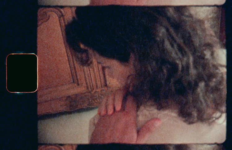 Man touches womans shoulder and she reaches up to touch the hand
