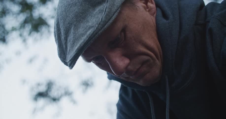 A man is outdoors in winter during the day