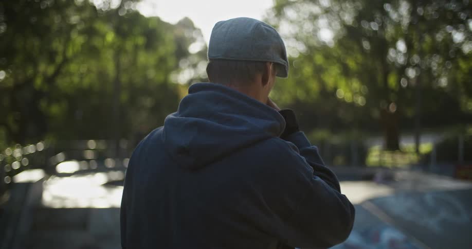 Man standing in front of a skate park at morning