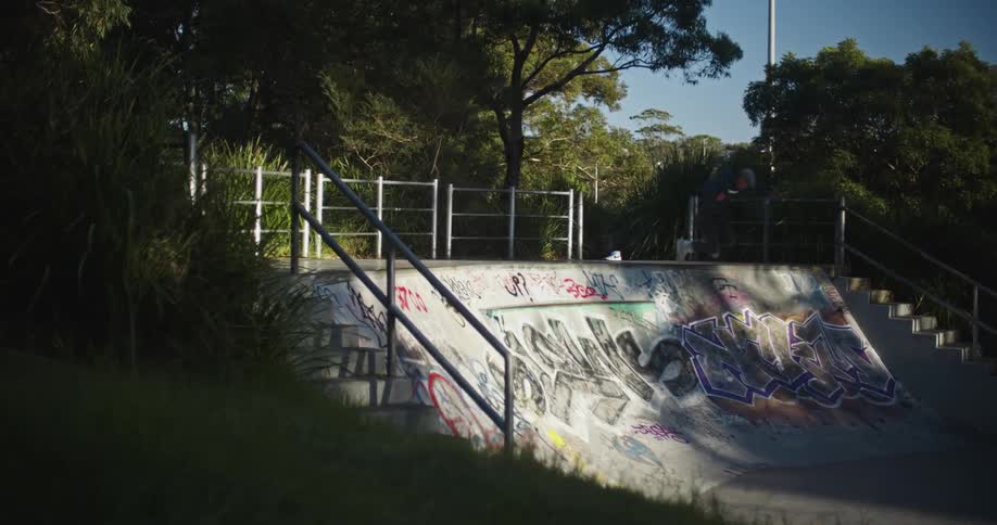 A rollerblader skating in a graffiti covered skate park