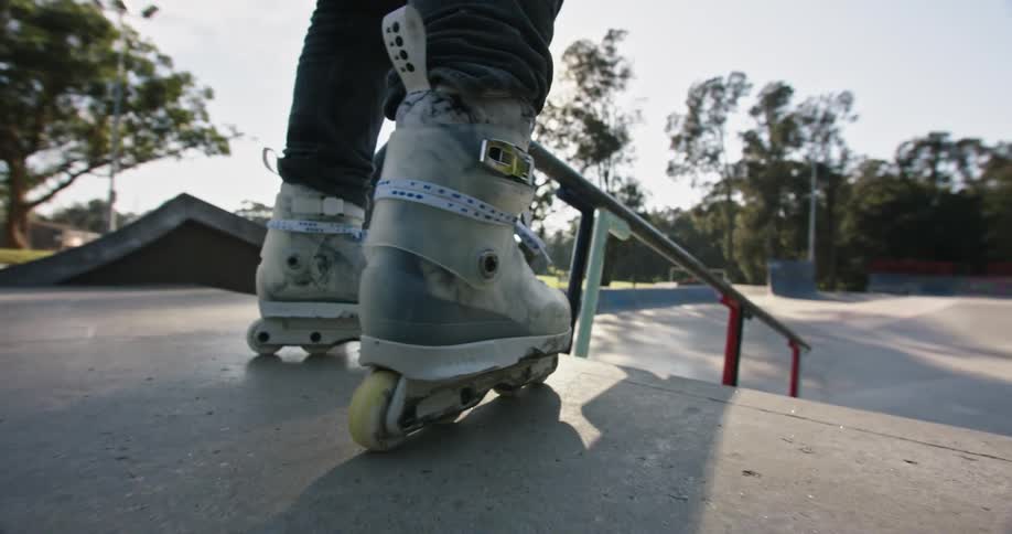 A person rollerblading in a skatepark on a summer day