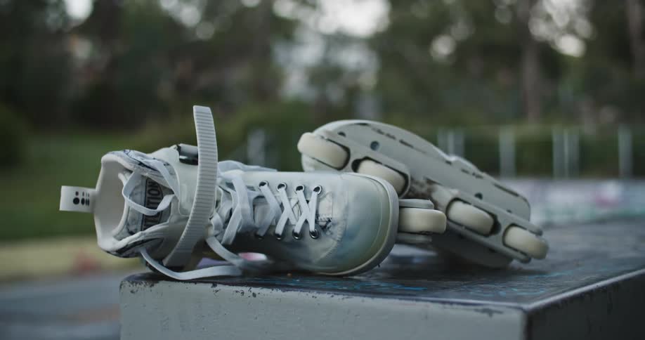 A pair of roller blades are left at a public park