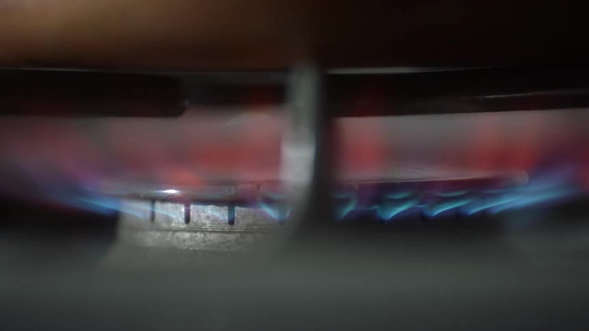 A fire igniting on a gas stovetop