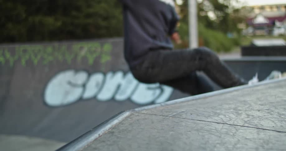 Older man roller blades up a ramp then back down again