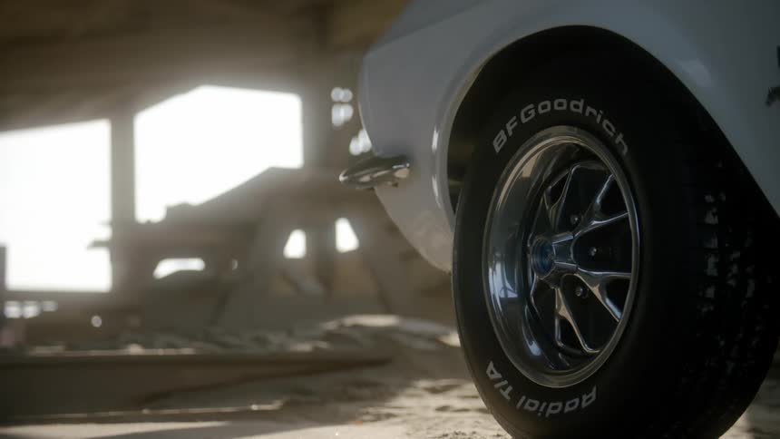 Close up of the wheel of a car parked in a construction site at evening
