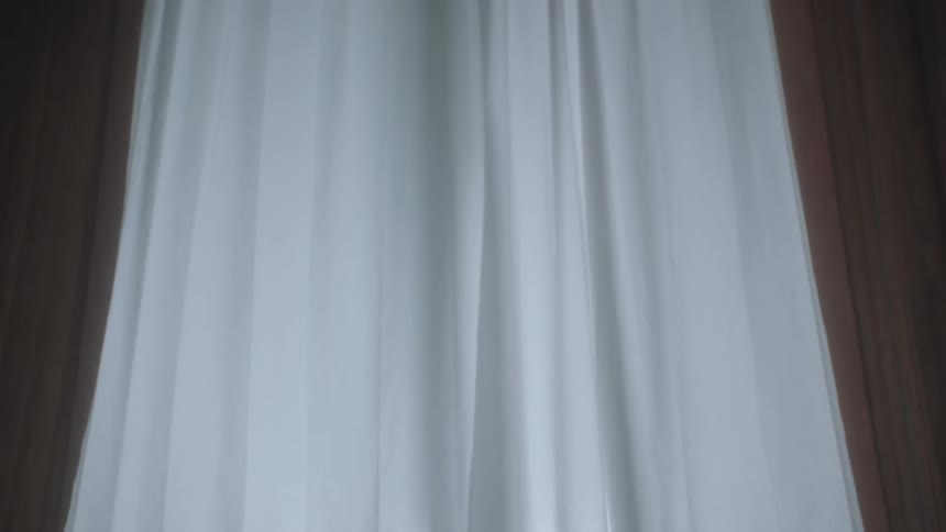 Curtains are covering a window in a house