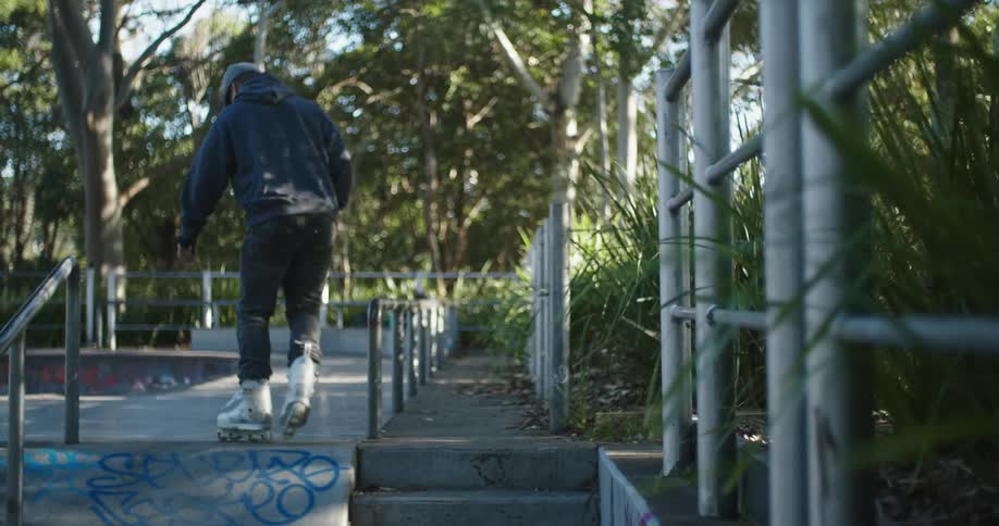 Man wearing skates enters a skating park at morning