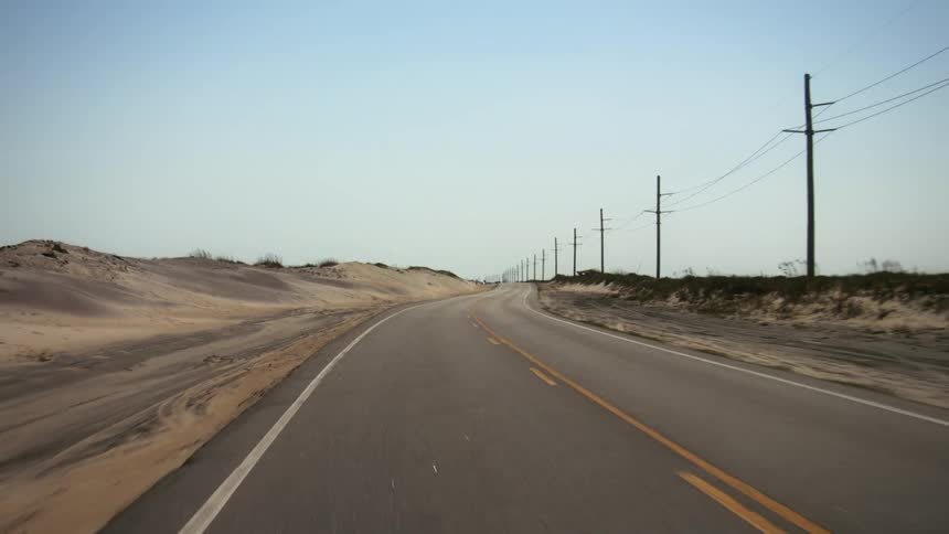 A view driving down a road in a rural area