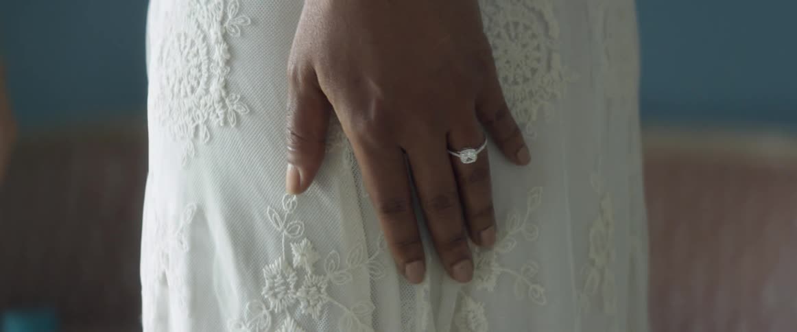 A woman is wearing a wedding dress indoors